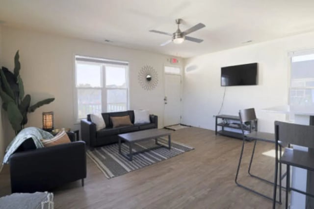 Black couches coffee table rug ceiling fan living room at Clemson Village in Clemson Student Accommodation