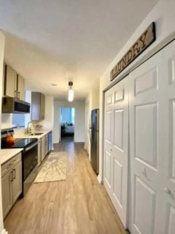 Kitchen with appliances and double doors laundry room at Clemson Village in Clemson Student Accommodation