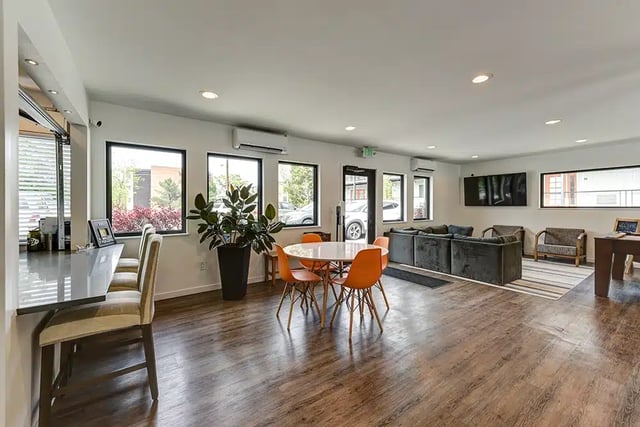 Bar stools round table couches and television lounge area at The Lodge in Boulder Student Accommodation