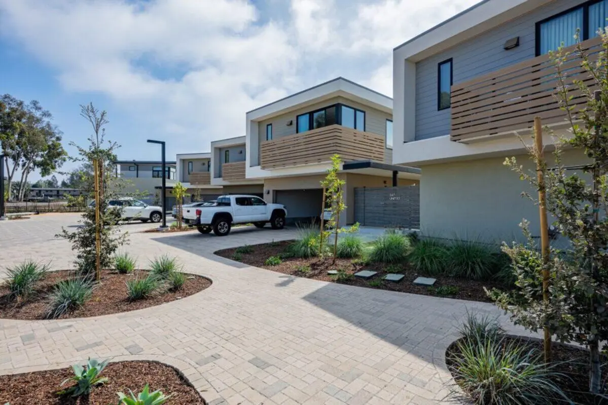 Modern townhouses with cars and landscaping exterior at The Cove Santa Barbara in Isla Vista Student Accommodation