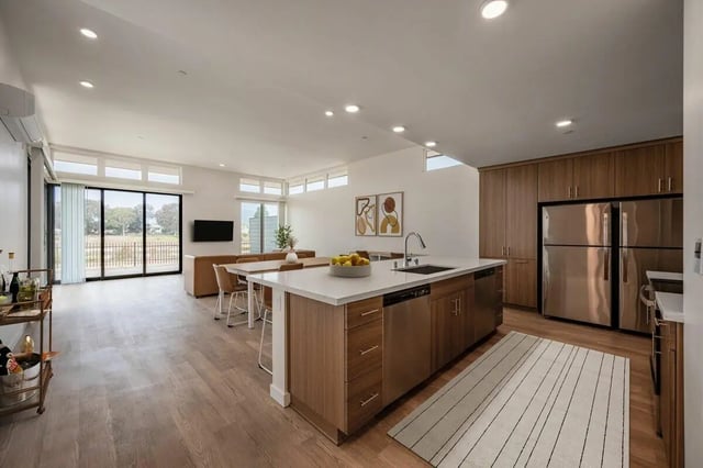 Kitchen island dining area living room and exterior. at The Cove Santa Barbara in Isla Vista Student Accommodation