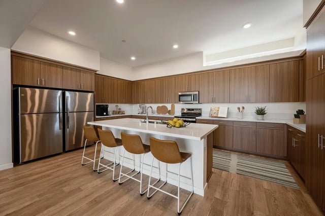 Stainless steel fridge island with stools kitchen at The Cove Santa Barbara in Isla Vista Student Accommodation