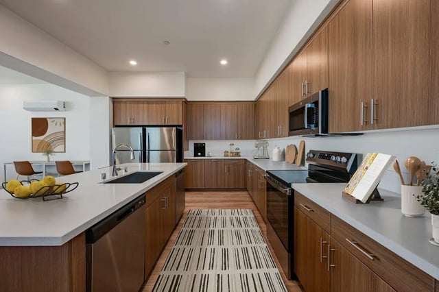 Modern kitchen with island appliances and cabinetry kitchen at The Cove Santa Barbara in Isla Vista Student Accommodation