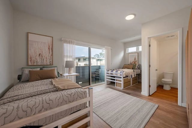 Two beds and toilet in student room bedroom at The Cove Santa Barbara in Isla Vista Student Accommodation