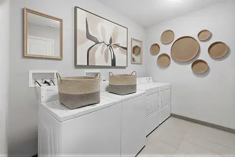 Washers dryers baskets wall decor laundry room at Polk On Third - Off Campus Student Housing in Bethlehem Student Accommodation