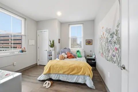 Bed with stuffed animals tapestry bedroom at Polk On Third - Off Campus Student Housing in Bethlehem Student Accommodation