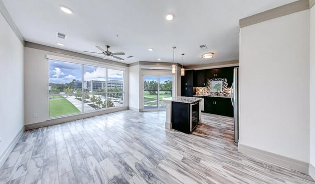 Modern kitchen island with island and pendant lights living room at Cascades Luxury Apartments in Gainesville Student Accommodation