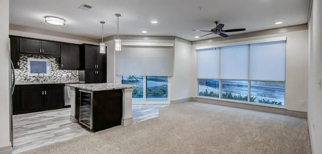 Kitchen island dark cabinets sink open living area at Cascades Luxury Apartments in Gainesville Student Accommodation