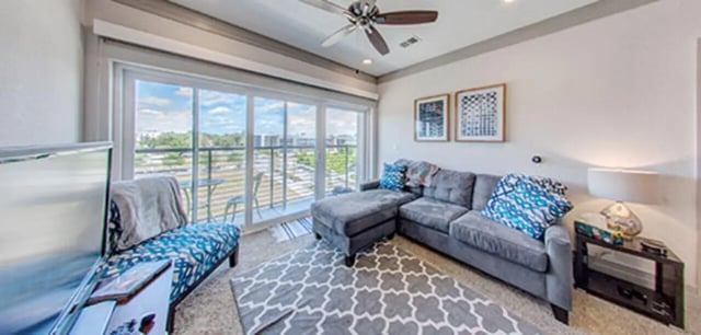 Sectional couch patterned bench wall art living room at Cascades Luxury Apartments in Gainesville Student Accommodation
