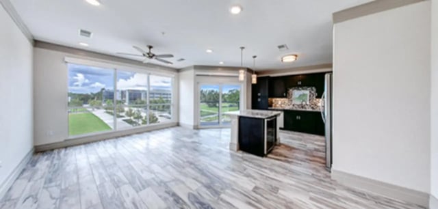 Modern kitchen island and large windows living room at Cascades Luxury Apartments in Gainesville Student Accommodation