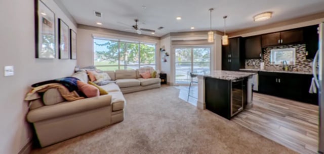 Sofa, kitchen island, dark cabinets, living room at Cascades Luxury Apartments in Gainesville Student Accommodation