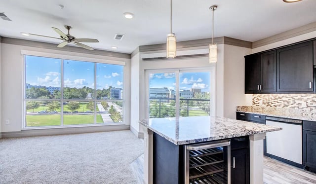 Kitchen island pendant lights dark cabinets kitchen at Cascades Luxury Apartments in Gainesville Student Accommodation