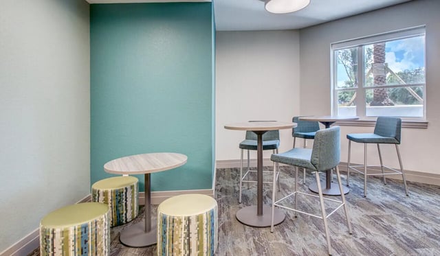 Tops tables stools lounge area at Cascades Luxury Apartments in Gainesville Student Accommodation