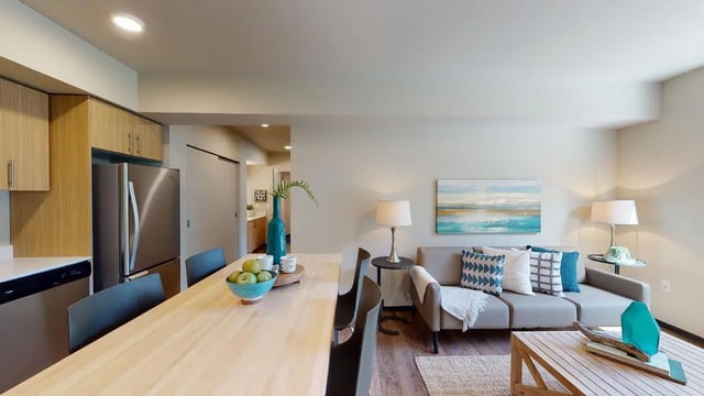 Kitchen and living area with couch dining table Image Type at 7000 Campus Living Apartments in Shoreline Student Accommodation