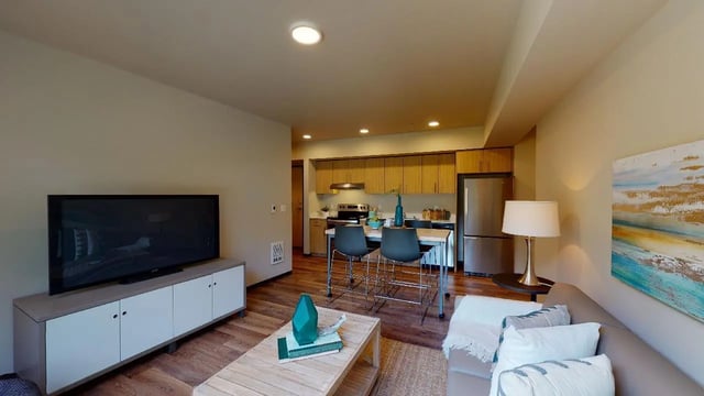TV kitchen island and couch living room at 7000 Campus Living Apartments in Shoreline Student Accommodation