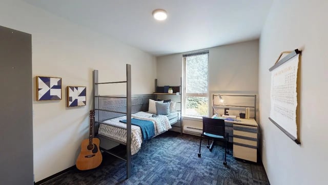 Bunk bed desk guitar art framed bedroom at 7000 Campus Living Apartments in Shoreline Student Accommodation