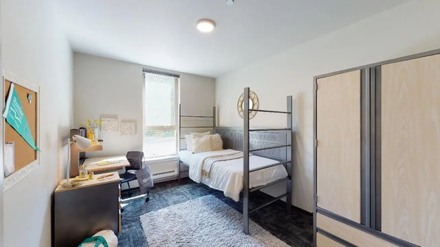 Bunk bed desk rug and wardrobe bedroom at 7000 Campus Living Apartments in Shoreline Student Accommodation