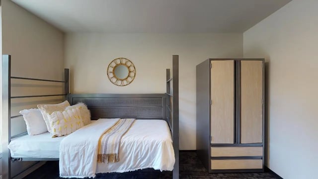Bunk bed with decorative pillows and wardrobe bedroom at 7000 Campus Living Apartments in Shoreline Student Accommodation