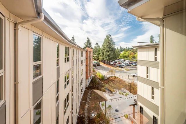 Modern building exterior with windows and parking lot exterior at 7000 Campus Living Apartments in Shoreline Student Accommodation
