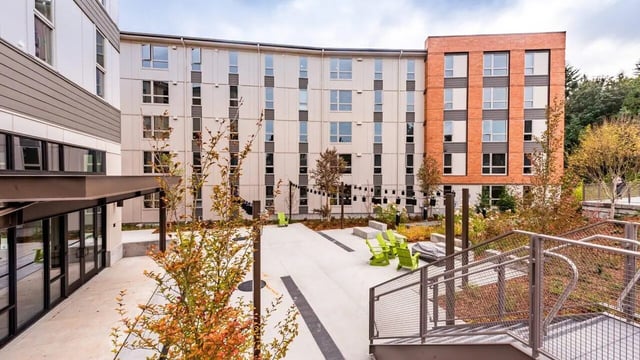 Courtyard with green chairs building exterior exterior at 7000 Campus Living Apartments in Shoreline Student Accommodation