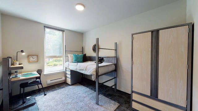 Bunk bed desk closet light rug bedroom at 7000 Campus Living Apartments in Shoreline Student Accommodation