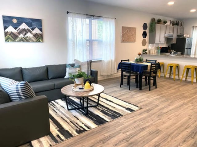 Modern living room with sofa dining table kitchen living room at The Rail Yard in Newark Student Accommodation
