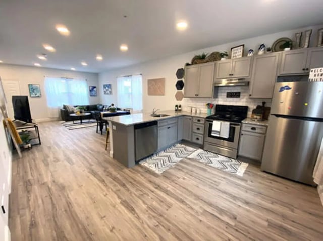 Kitchen with island stainless steel appliances living room kitchen at The Rail Yard in Newark Student Accommodation