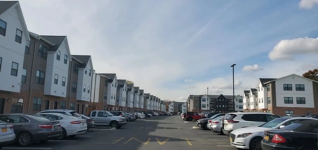 Apartment buildings and parked cars exterior at The Rail Yard in Newark Student Accommodation