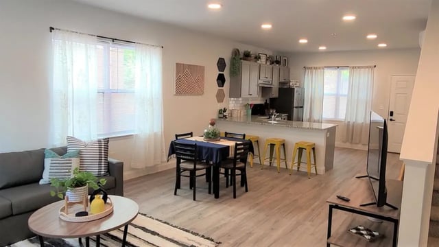 Sofa dining table kitchen with bar stools living room at The Rail Yard in Newark Student Accommodation