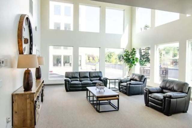 Lounge with black leather sofas coffee table living room at Sundance Apartments - BYU-Idaho Approved Housing in Rexburg Student Accommodation