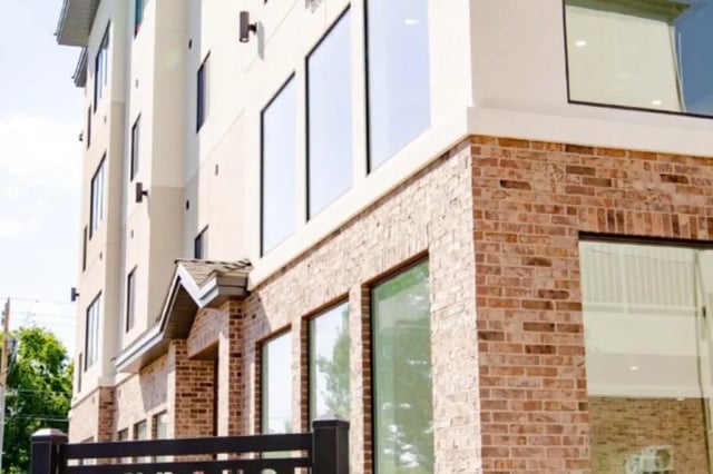 Modern building with brick and large windows exterior at Sundance Apartments - BYU-Idaho Approved Housing in Rexburg Student Accommodation