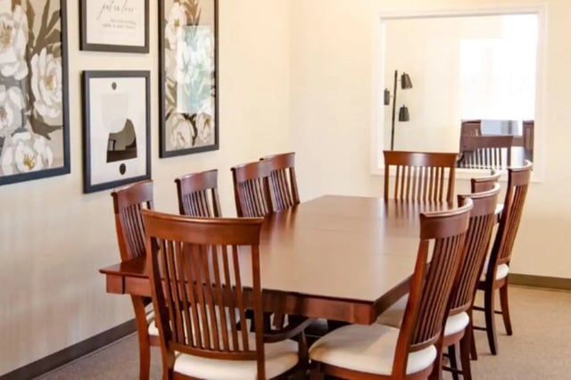 Large wooden table eight chairs wall art dining room at Sundance Apartments - BYU-Idaho Approved Housing in Rexburg Student Accommodation