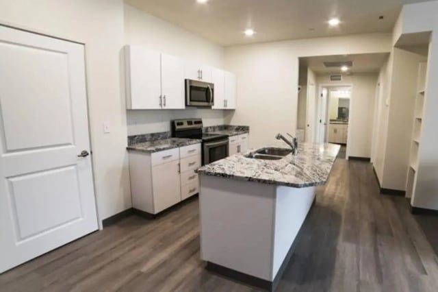 White cabinets countertops sink island kitchen at Sundance Apartments - BYU-Idaho Approved Housing in Rexburg Student Accommodation
