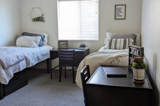 Two beds desks chairs and wall art bedroom at Sundance Apartments - BYU-Idaho Approved Housing in Rexburg Student Accommodation