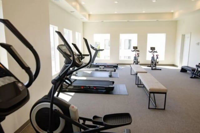 Elliptical treadmills exercise bikes and benches fitness center at Sundance Apartments - BYU-Idaho Approved Housing in Rexburg Student Accommodation