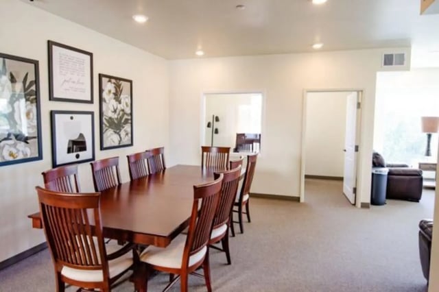Large dining table with chairs artwork communal living area at Sundance Apartments - BYU-Idaho Approved Housing in Rexburg Student Accommodation