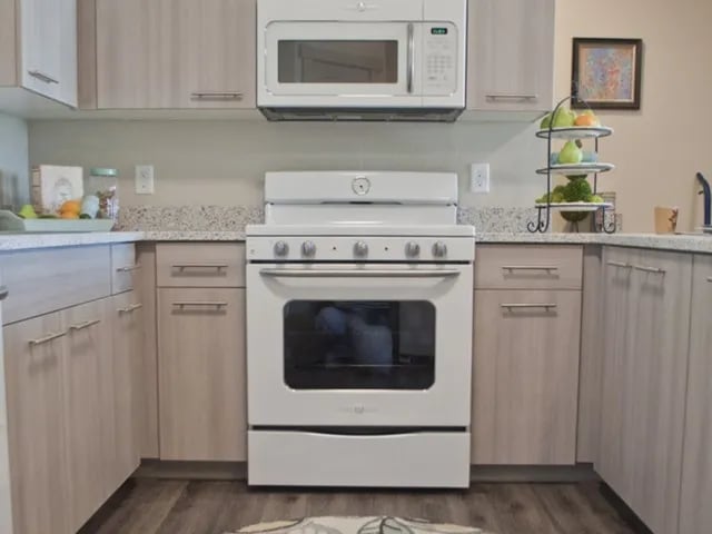 White stove microwave fruit bowl kitchen at The Towers Two - Women Approved Housing in Rexburg Student Accommodation