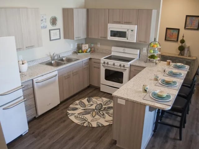 Kitchen with appliances island seating and dining set kitchen at The Towers Two - Women Approved Housing in Rexburg Student Accommodation