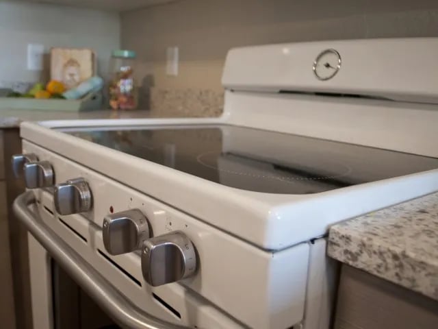 White electric stove with silver knobs kitchen at The Towers Two - Women Approved Housing in Rexburg Student Accommodation
