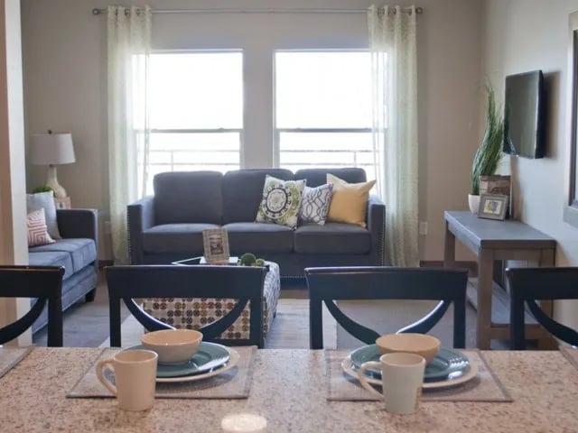 Two sofas coffee table and dining set living room at The Towers Two - Women Approved Housing in Rexburg Student Accommodation