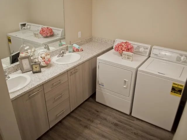 Two sinks laundry machines vanity and mirrors laundry room at The Towers Two - Women Approved Housing in Rexburg Student Accommodation