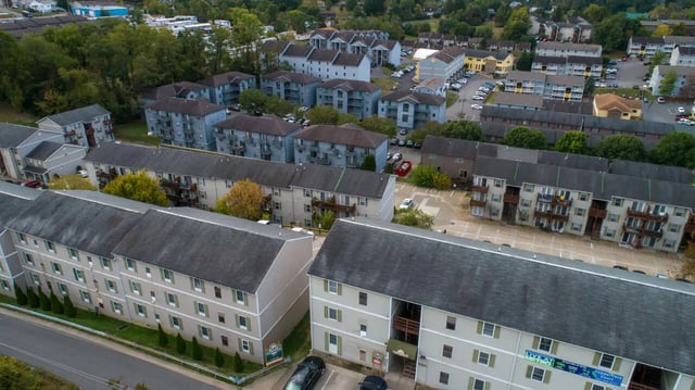 Apartment buildings with balconies and parking exterior at Copperfield Court in Morgantown Student Accommodation