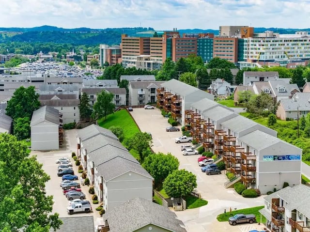 Apartment buildings with balconies and parked cars exterior at Copperfield Court in Morgantown Student Accommodation