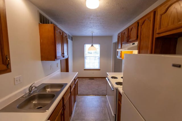 Sink cabinets window stove refrigerator kitchen at Copperfield Court in Morgantown Student Accommodation