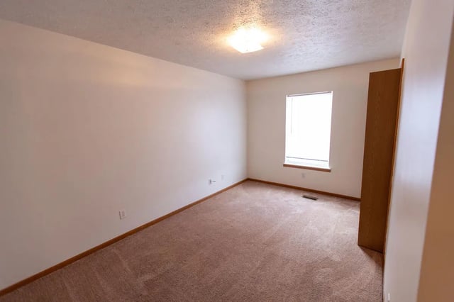 Empty room wood closet window bedroom at Copperfield Court in Morgantown Student Accommodation