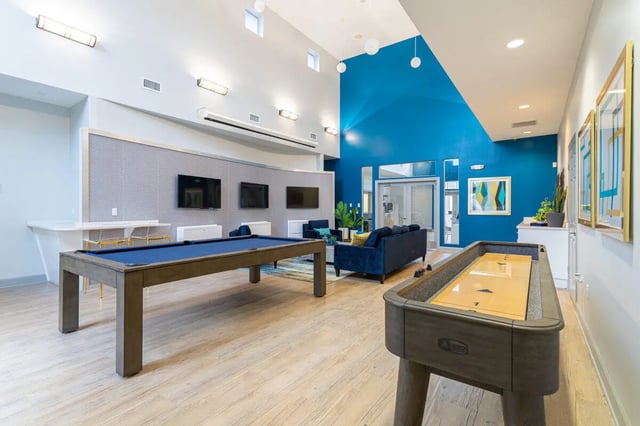 Pool and shuffleboard tables lounge area living room at Hawks Landing in Oxford Student Accommodation