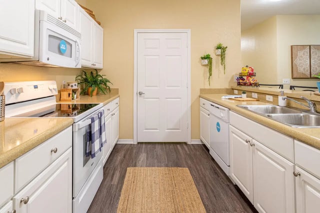 White cabinets microwave stove dishwasher sink kitchen at Hawks Landing in Oxford Student Accommodation