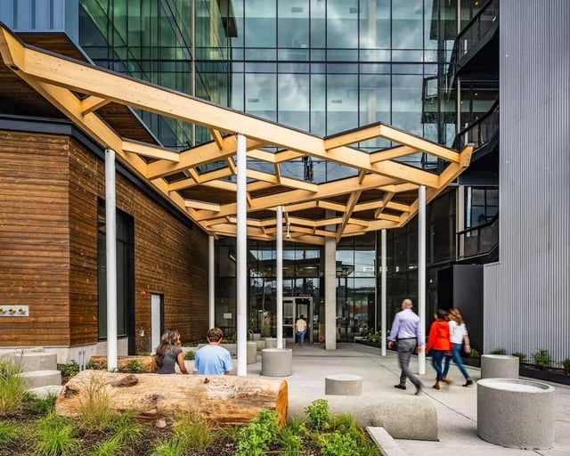 Exterior with people under wooden canopy entrance at Blanton Turner in Seattle Student Accommodation