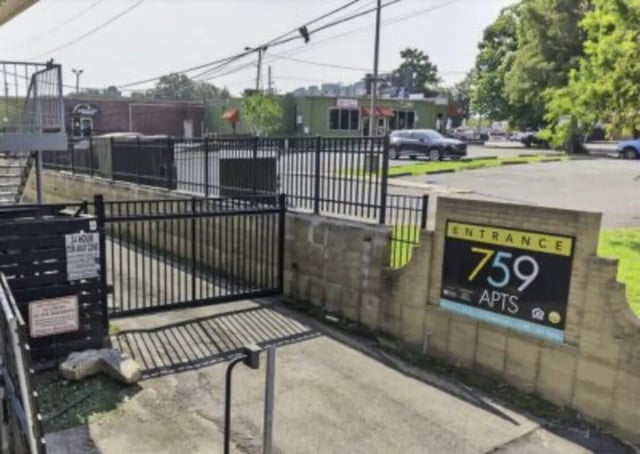 Entrance sign and gate building exterior at 759 Basin LLC in Tallahassee Student Accommodation
