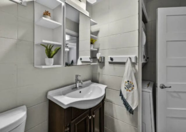 Sink cabinet shelves towel laundry machine bathroom at 759 Basin LLC in Tallahassee Student Accommodation